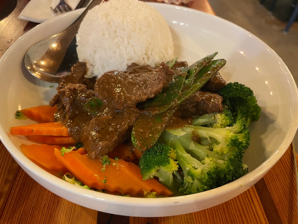 Beef rendang served with vegetables and rice
