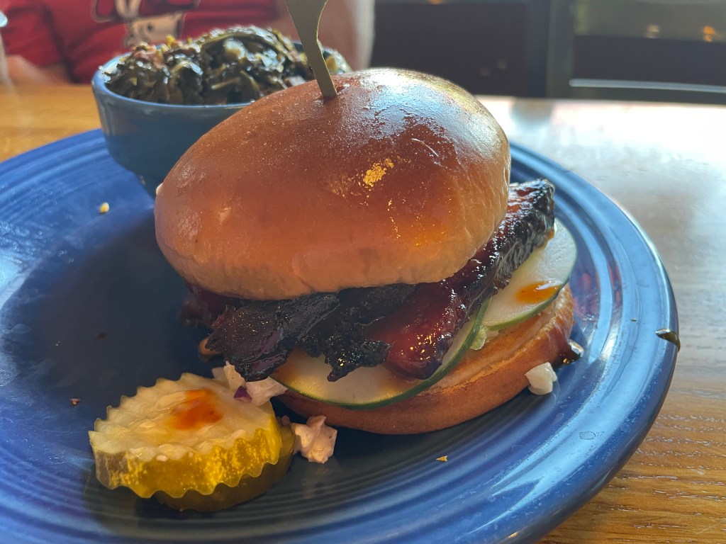 Korean Pork Belly BBQ sandwich with a side of collards