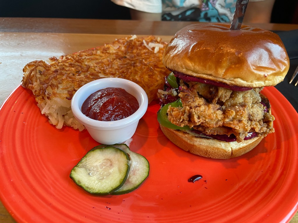 fried chicken sandwich with fresh jalapeños, blueberry compote, and blueberry aioli with hashbrowns