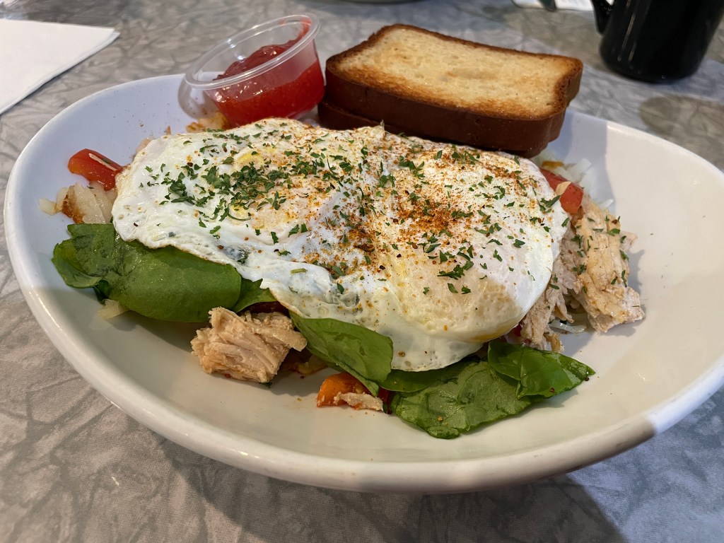 A skizzle with turkey, spinach, tomatoes, eggs, gluten-free bread and homemade strawberry jelly